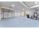 Spacious three car garage with updated epoxy flooring, sink, water heater, and storage space at 28 Hudson Bay Ln, Greenwood, IN 46142