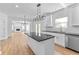 Gourmet kitchen boasts white cabinets, a black island, and stainless steel appliances at 28 Hudson Bay Ln, Greenwood, IN 46142