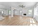 Open-concept living room with hardwood floors, fireplace, and sunlit windows at 28 Hudson Bay Ln, Greenwood, IN 46142