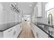 Open-concept living with kitchen island, hardwood floors and elegant chandelier lighting at 28 Hudson Bay Ln, Greenwood, IN 46142