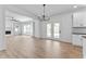 Open floor plan with kitchen, living room, and dining area all with hardwood flooring at 28 Hudson Bay Ln, Greenwood, IN 46142