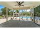 Covered patio with tile flooring offering views of the backyard pool and surrounding landscape at 28 Hudson Bay Ln, Greenwood, IN 46142