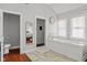 Bright bathroom featuring a tub, stand up shower, wood-look flooring and stylish fixtures at 2919 Macpherson Ave, Indianapolis, IN 46205