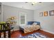 Bright, cozy bedroom features a crib, twin bed, playful decor, and hardwood floors at 2919 Macpherson Ave, Indianapolis, IN 46205