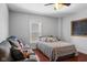 Cozy bedroom featuring a comfortable bed, a small couch, and a chalkboard for added character at 2919 Macpherson Ave, Indianapolis, IN 46205