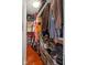 Walk-in closet with wood flooring, organized shelves, hanging clothes, and overhead storage at 2919 Macpherson Ave, Indianapolis, IN 46205