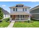 Charming two-story home with a welcoming front porch, stone accents, and a well-manicured lawn at 2919 Macpherson Ave, Indianapolis, IN 46205