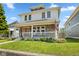Charming two-story home with a cozy front porch and well-maintained lawn at 2919 Macpherson Ave, Indianapolis, IN 46205