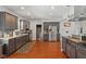 Spacious kitchen featuring stainless steel appliances, dark cabinetry and a patterned rug at 2919 Macpherson Ave, Indianapolis, IN 46205