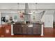 Bright, open concept kitchen island with granite countertops, stone backsplash and stainless vent hood at 2919 Macpherson Ave, Indianapolis, IN 46205