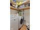 Bright laundry room with updated washer and dryer, storage shelving at 2919 Macpherson Ave, Indianapolis, IN 46205