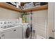 Laundry room with updated washer, dryer, and storage shelving at 2919 Macpherson Ave, Indianapolis, IN 46205