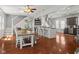 Open-concept living and dining area with hardwood floors, modern lighting, and kitchen with island at 2919 Macpherson Ave, Indianapolis, IN 46205