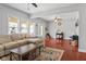 Open concept living room with hardwood floors, sectional sofa, and bright natural light at 2919 Macpherson Ave, Indianapolis, IN 46205