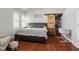 Bedroom with queen-sized bed, hardwood floors, and a barn door closet at 2919 Macpherson Ave, Indianapolis, IN 46205