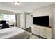 Inviting bedroom with a plush bed, stylish rug, dark wood floors, and ample natural light at 3002 Horse Hill W Dr, Indianapolis, IN 46214