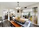 Bright dining area with a wooden table and bench seating, open to the kitchen and sunroom at 3002 Horse Hill W Dr, Indianapolis, IN 46214