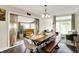 Open-concept dining room, seamlessly connected to living room and sunroom with bench seating at 3002 Horse Hill W Dr, Indianapolis, IN 46214