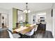 Dining room with a table, chairs, and a view into the updated kitchen with barstool seating at 3002 Horse Hill W Dr, Indianapolis, IN 46214