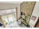 Aerial view of the living room featuring a stone fireplace, sliding glass doors, and modern decor at 3002 Horse Hill W Dr, Indianapolis, IN 46214