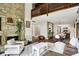 Open-concept living room with stone fireplace, modern furniture, and hardwood floors at 3002 Horse Hill W Dr, Indianapolis, IN 46214