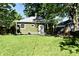 Charming backyard with green lawn, patio, and mature trees offering shade at 3021 Eastern Ave, Indianapolis, IN 46218