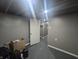 An unfinished basement featuring an open door and storage of personal items at 3021 Eastern Ave, Indianapolis, IN 46218