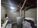 A basement laundry area with a washing machine and an exposed ceiling at 3021 Eastern Ave, Indianapolis, IN 46218