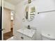 Bright bathroom with a stylish marble vanity and a round mirror with views of a shower at 3021 Eastern Ave, Indianapolis, IN 46218
