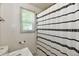 A clean bathroom featuring a shower with a stylish black-and-white patterned shower curtain at 3021 Eastern Ave, Indianapolis, IN 46218