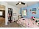 A charming bedroom featuring a well-organized closet and a cute decorated pink bed at 3021 Eastern Ave, Indianapolis, IN 46218