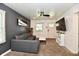 Contemporary living room with gray sofa, mounted TV, ceiling fan and modern decor at 3021 Eastern Ave, Indianapolis, IN 46218