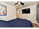Comfortable bedroom with ceiling fan, mounted TV, and access to the ensuite bathroom at 3021 Eastern Ave, Indianapolis, IN 46218