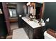 Bathroom featuring dual sink vanity, decorative mirror and black walls at 3110 W New York St, Indianapolis, IN 46222