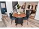 Dining room with a modern table, black chairs, and an open view to the kitchen and staircase at 3110 W New York St, Indianapolis, IN 46222