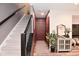 Welcoming foyer with staircase, featuring neutral decor and a stylish console table with mirror at 3110 W New York St, Indianapolis, IN 46222