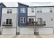 Modern townhome featuring a two-car garage, private balcony, and stylish, two-tone facade at 3110 W New York St, Indianapolis, IN 46222