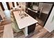 Kitchen island featuring seating and a sink with a view of the stainless appliances at 3110 W New York St, Indianapolis, IN 46222
