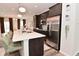 Bright open kitchen with stainless appliances, island with seating, and modern pendant lighting at 3110 W New York St, Indianapolis, IN 46222