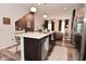 Open kitchen features island seating, stainless dishwasher, and view into the living room at 3110 W New York St, Indianapolis, IN 46222