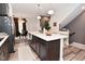 Well-lit kitchen boasts a spacious island with seating, stylish pendant lights, and modern appliances at 3110 W New York St, Indianapolis, IN 46222