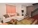 Cozy living area with a comfortable sectional, decor, and a glimpse of the staircase at 3110 W New York St, Indianapolis, IN 46222