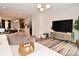 Bright living room with hardwood floors, modern lighting, and open layout to the kitchen at 3110 W New York St, Indianapolis, IN 46222