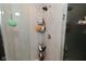 Modern glass shower with tiled walls, shower head, and convenient shelving at 3110 W New York St, Indianapolis, IN 46222