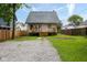 View of the home's backyard, with small wooden deck at 3216 N Kenwood Ave, Indianapolis, IN 46208