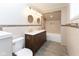 Elegant bathroom featuring a double vanity with decorative mirrors and fixtures, accented by stylish tile work at 3216 N Kenwood Ave, Indianapolis, IN 46208