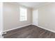 This bedroom features wood-look flooring, neutral walls, and a window, creating a serene and relaxing atmosphere at 3216 N Kenwood Ave, Indianapolis, IN 46208