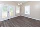 Bright dining area with natural light from door and windows, complemented by the warm, wood-look flooring at 3216 N Kenwood Ave, Indianapolis, IN 46208