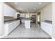 Modern kitchen boasting white cabinets, granite countertops, and stainless steel appliances at 3216 N Kenwood Ave, Indianapolis, IN 46208