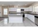 This kitchen showcases white cabinetry, granite countertops, stainless steel appliances, and a convenient center island at 3216 N Kenwood Ave, Indianapolis, IN 46208
